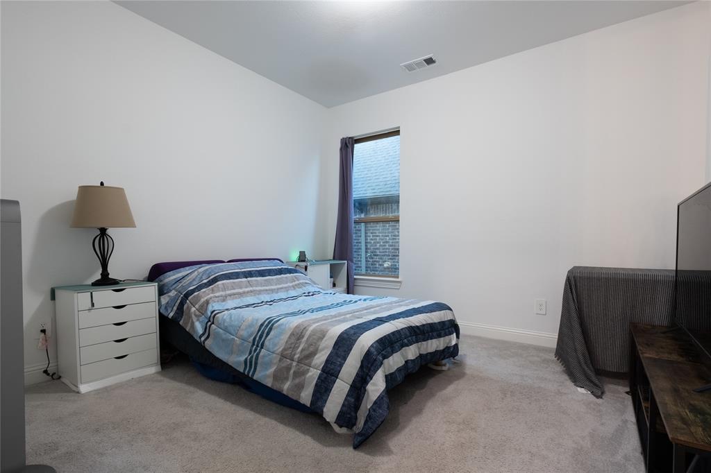 Neutral wall tones, wall-to-wall carpeting, and a single vertical window