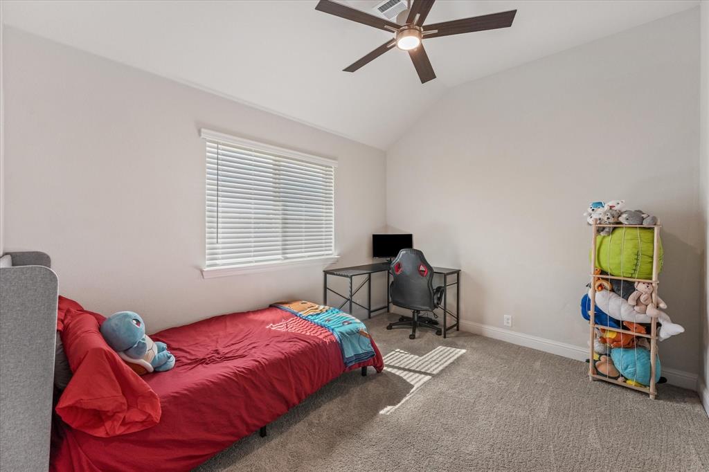 Bedroom 4 featuring a vaulted ceiling, neutral wall tones, plush wall-to-wall carpeting, horizontal blinds, and a multi-blade ceiling fan with integrated lighting