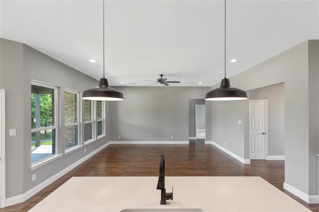 Unfurnished living room featuring dark wood-type flooring, recessed lighting, and a ceiling fan