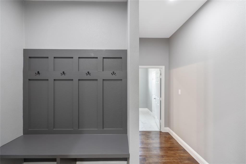 Mudroom with dark wood-style floors and baseboards