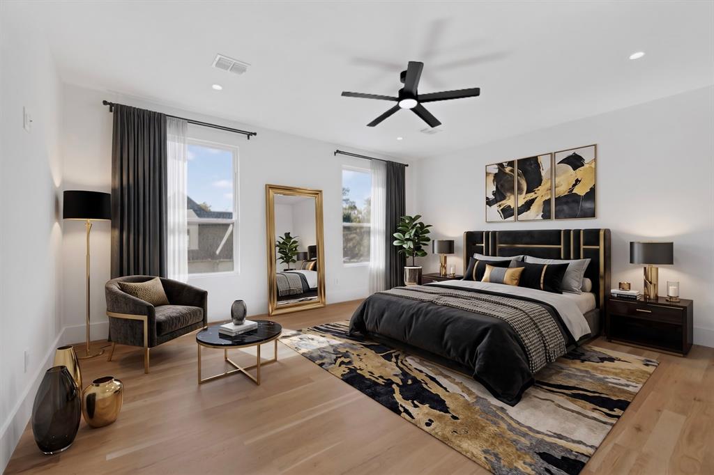 Light-filled room featuring wood-finish flooring, recessed lighting, and a modern matte black ceiling fan