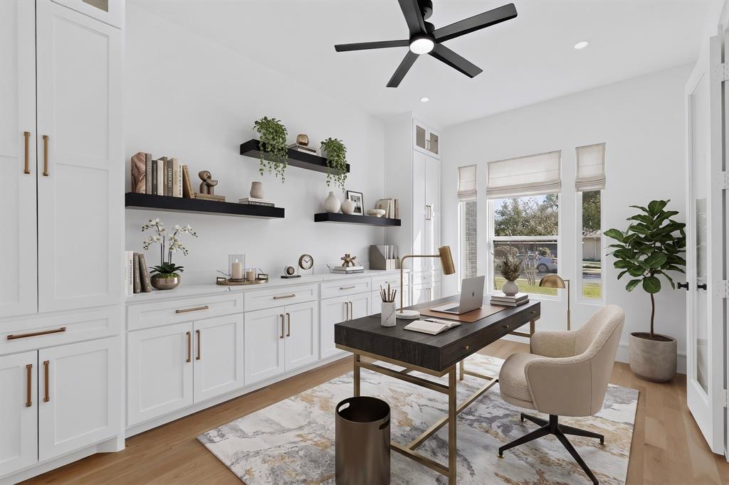 Custom white cabinetry with metallic hardware, wood-finish flooring, floating wall shelves, and a ceiling-mounted fan with integrated lighting