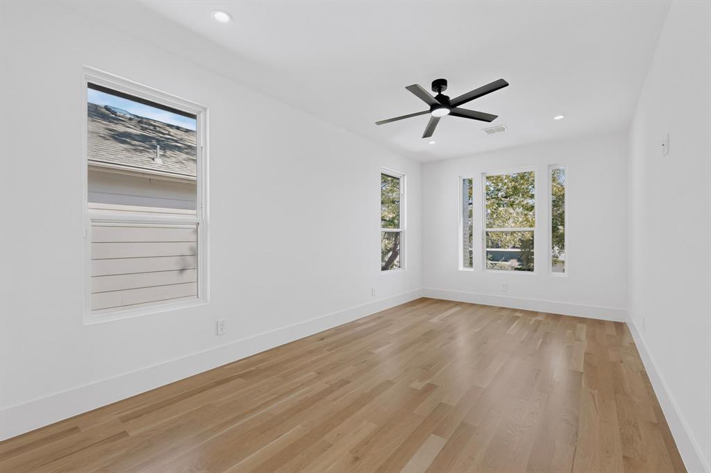 Interior space featuring wood-finish flooring, recessed lighting, and a modern ceiling fan with integrated lighting