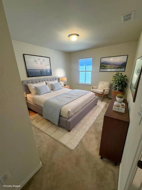Bedroom featuring light colored carpet