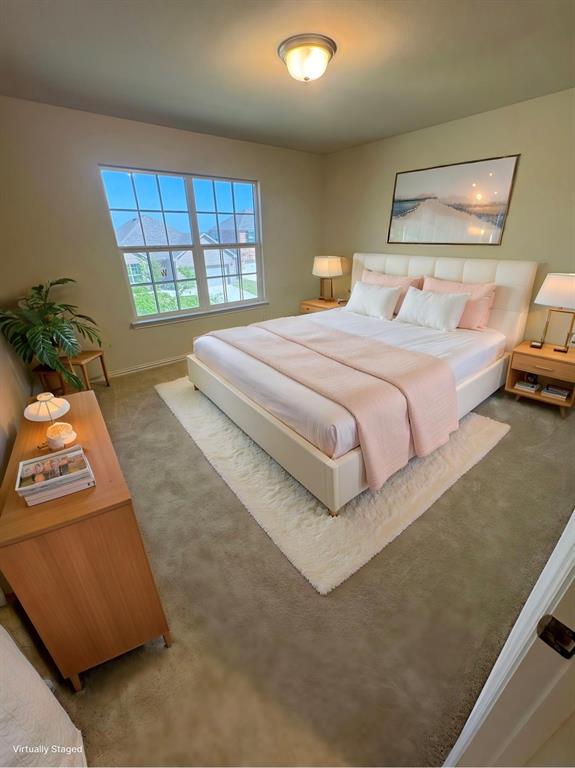 Carpeted bedroom featuring baseboards