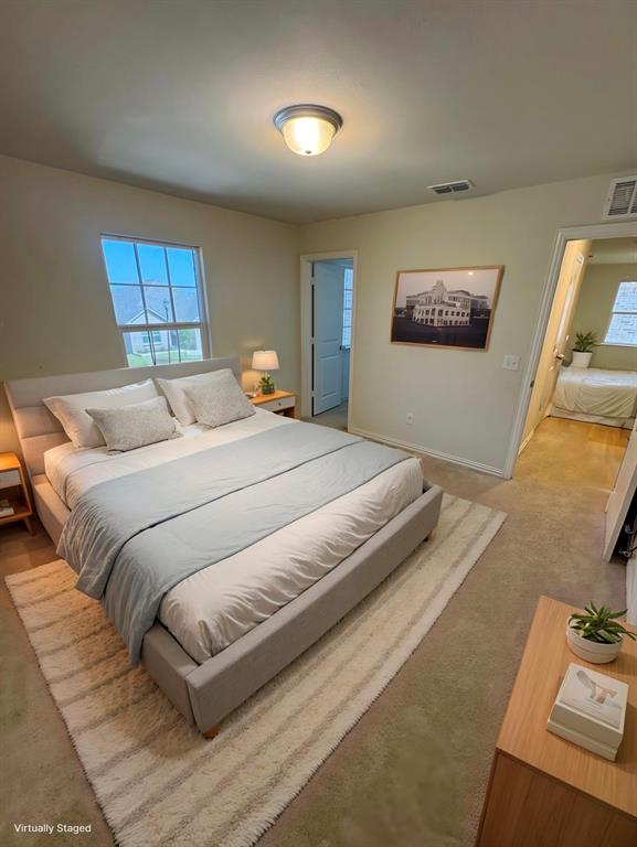 Carpeted bedroom featuring baseboards