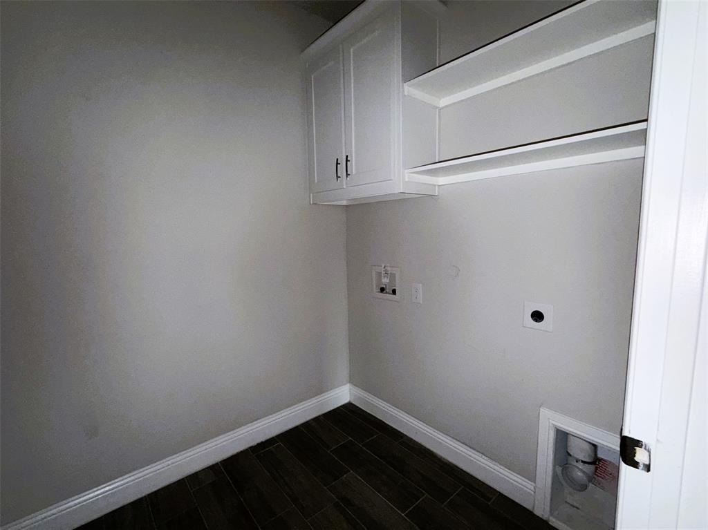 Separate utility room has plenty of shelf and cabinet storage and room for full size washer and dryer.