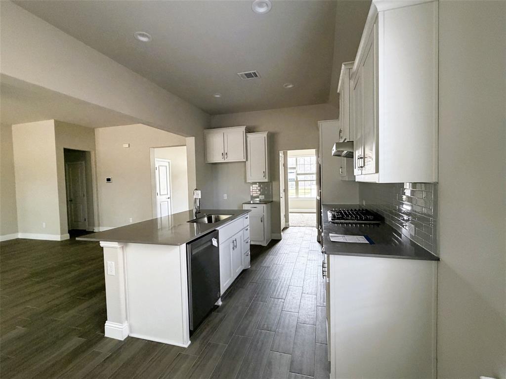 Island with breakfast bar transforms into a serving buffet during meals and gatherings.