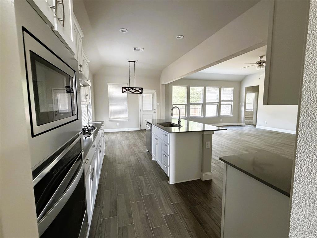 Chef's kitchen with quartz counters is open to living, perfect for holiday entertaining.