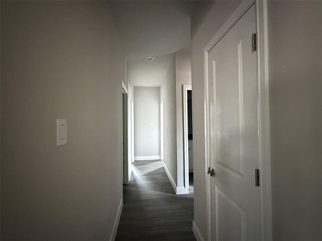 Hallway leads to additional bedrooms and bath.