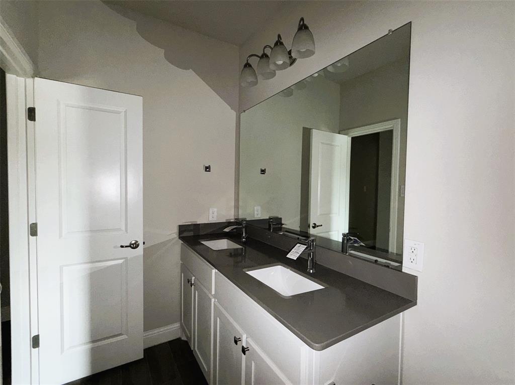 Reverse view shows off extended vanity with dual sinks and plenty of storage.
