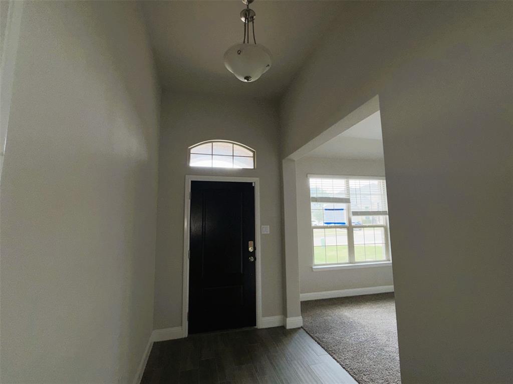 Grand entry with formal dining at right.