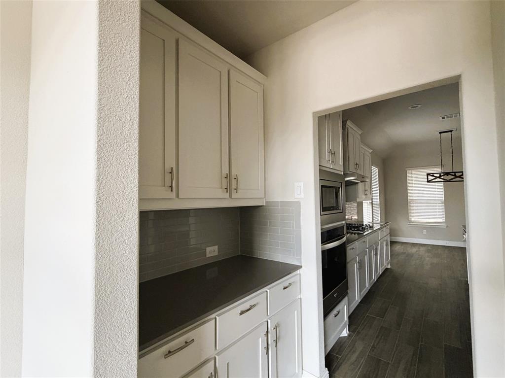 Butler's pantry leading into kitchen.