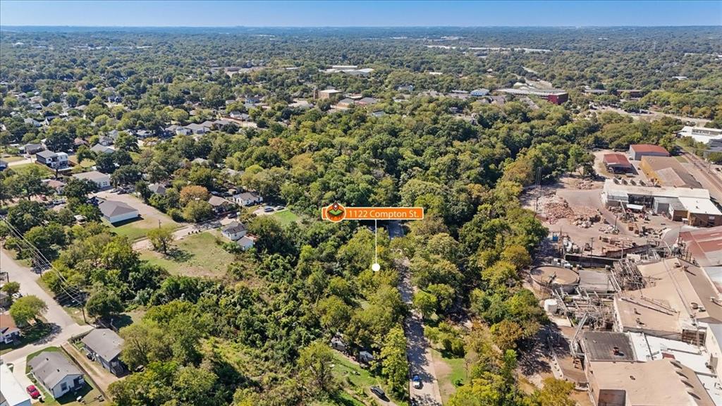 Aerial perspective of a wooded lot featuring dense mature tree cover and direct access to an established street
