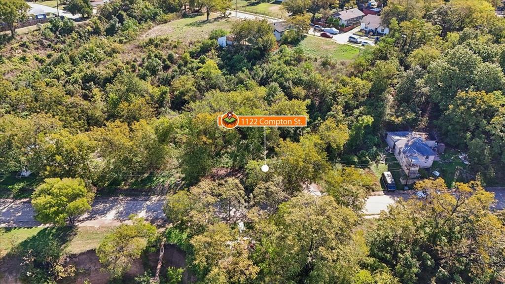 Aerial perspective of a heavily wooded lot featuring mature trees and established vegetation