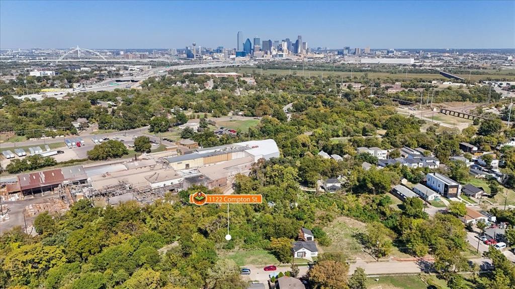 Aerial perspective featuring a lot with mature trees, established vegetation, and proximity to the city skyline