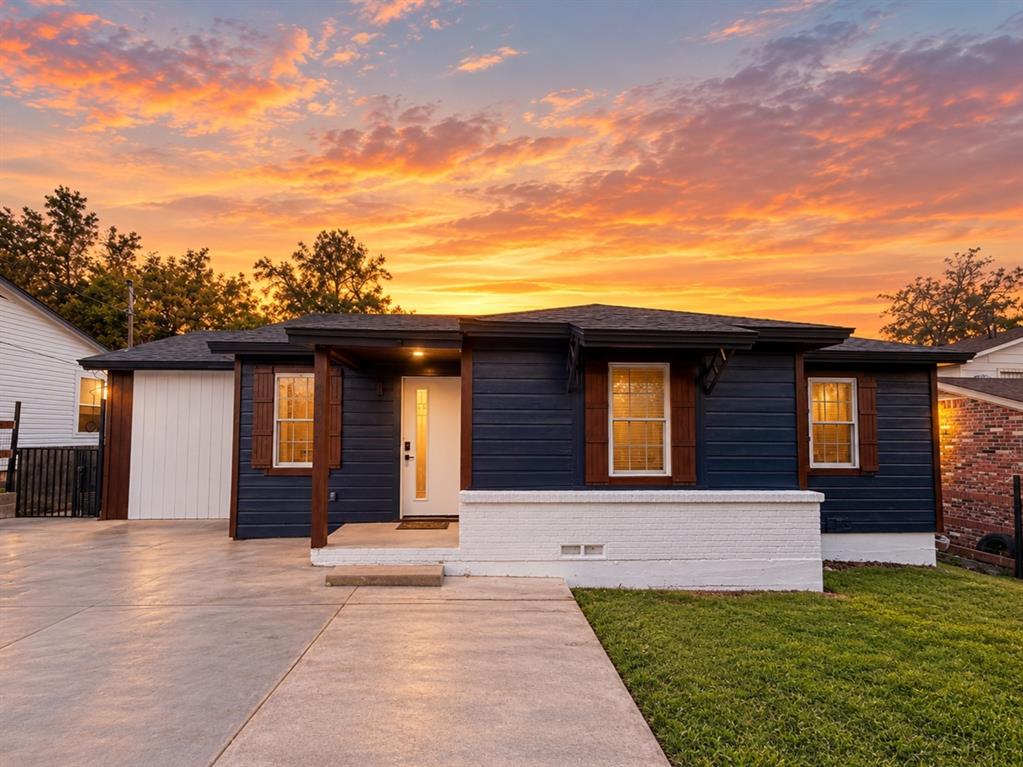 Exterior featuring horizontal siding, a contrasting painted brick foundation, shuttered windows, a covered front entry, and a concrete driveway Exterior featuring horizontal siding, a contrasting painted brick foundation, shuttered windows, a covered front entry, and a concrete driveway