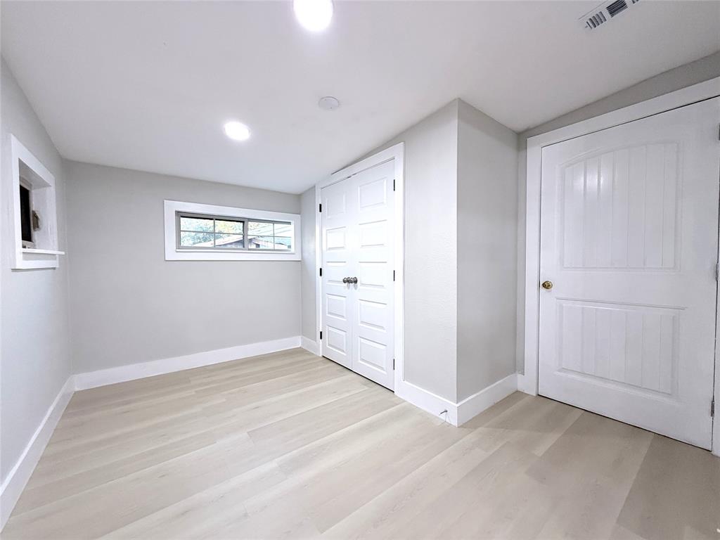 Light-toned wood-finish flooring, recessed lighting, double closet with multi-panel doors, and single-panel interior door