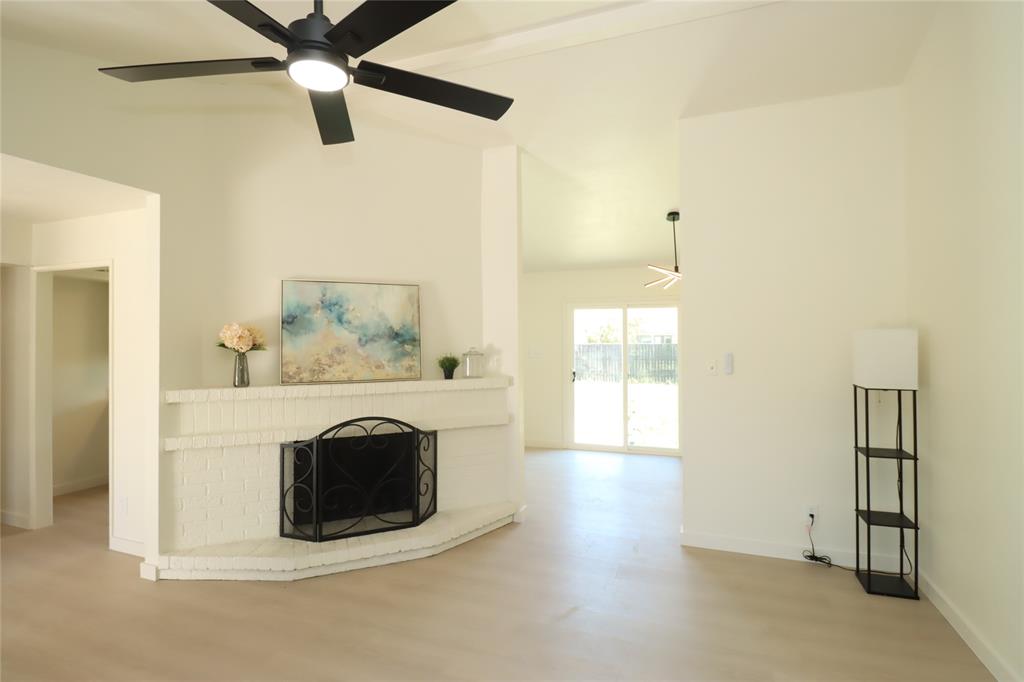 Corner fireplace featuring painted brick masonry, brand new sliding glass patio doors