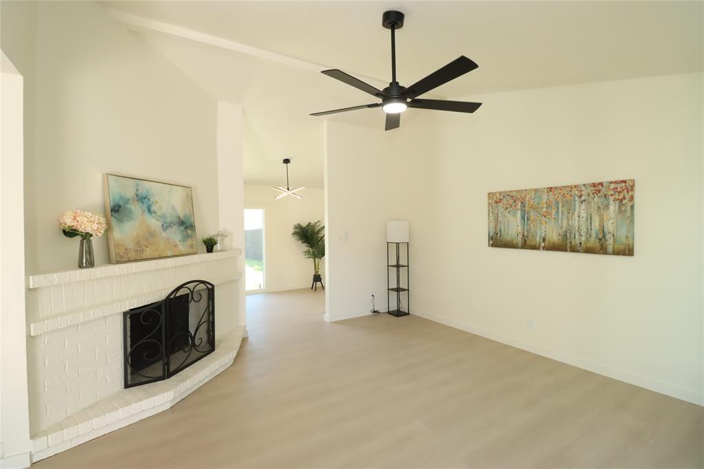 Vaulted ceilings, luxurious high end vinyl plank throughout, masonry fireplace with a raised hearth, and modern ceiling fans Vaulted ceilings, luxurious high end vinyl plank throughout, masonry fireplace with a raised hearth, and modern ceiling fans
