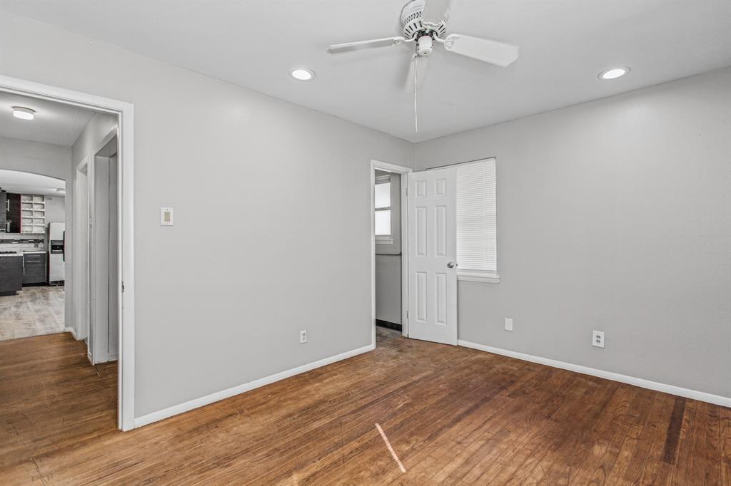 Room featuring wood-finish flooring, recessed lighting, and a white ceiling fan