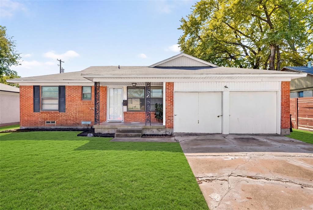 Single-story brick exterior featuring a covered front porch with decorative iron columns, an attached two-car garage, and a concrete driveway