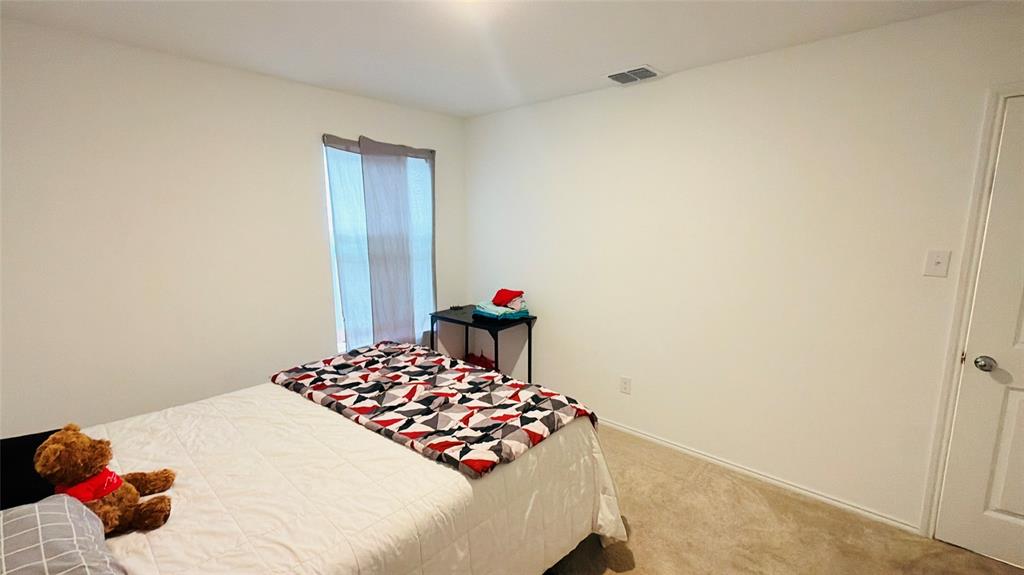 Neutral wall finishes, plush carpeting, a single-panel window, and a standard interior door