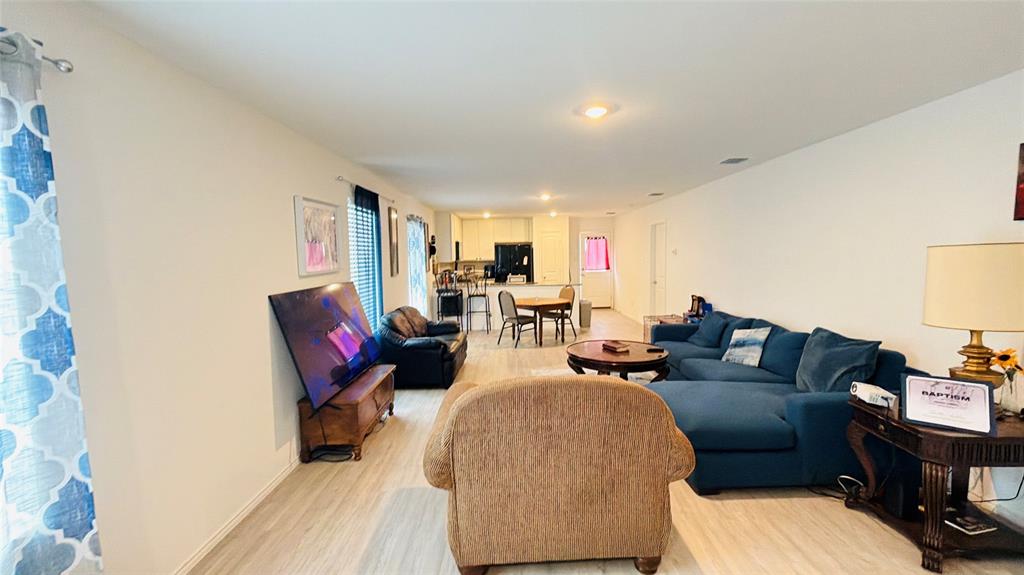 Open-concept interior featuring wood-finish flooring and recessed lighting