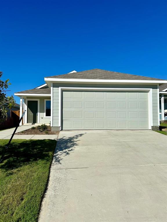 Single-story residence featuring horizontal lap siding, a concrete driveway, an attached two-car garage, and a hip roofline