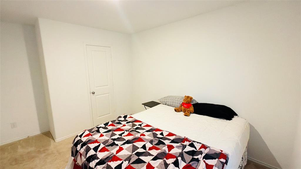 Neutral wall palette, carpeting, and interior two-panel door