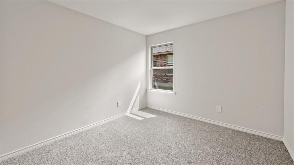 Neutral wall color with light gray carpeting and white trim