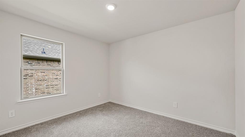 Recessed ceiling lighting, neutral wall paint, single pane window, and gray carpeting