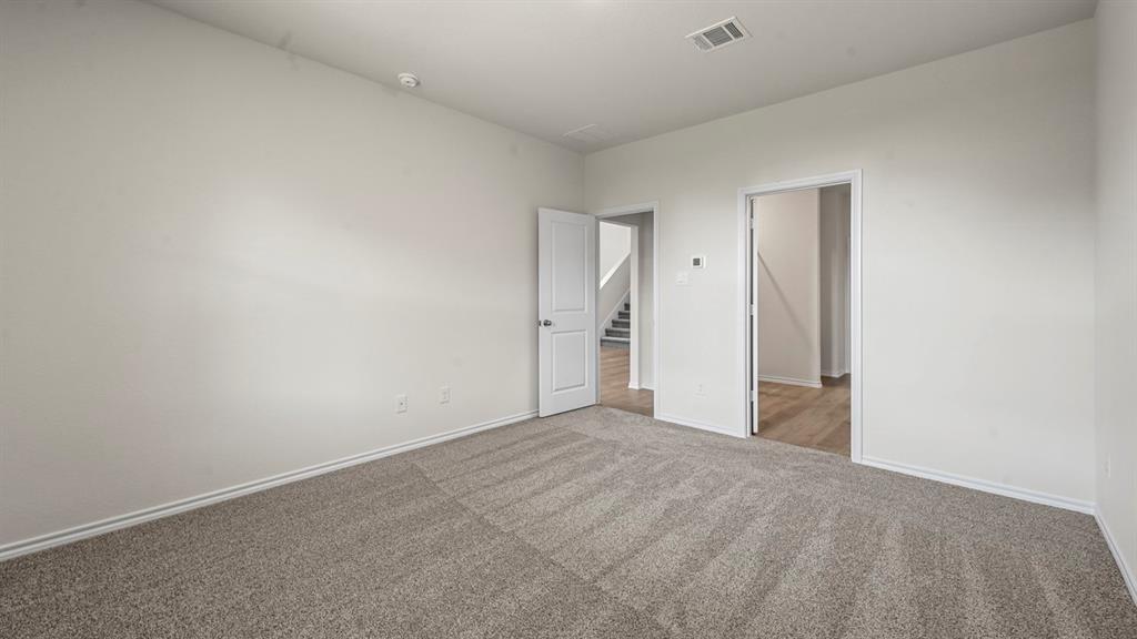 Neutral wall paint, gray carpet flooring, white trim, and white interior doors