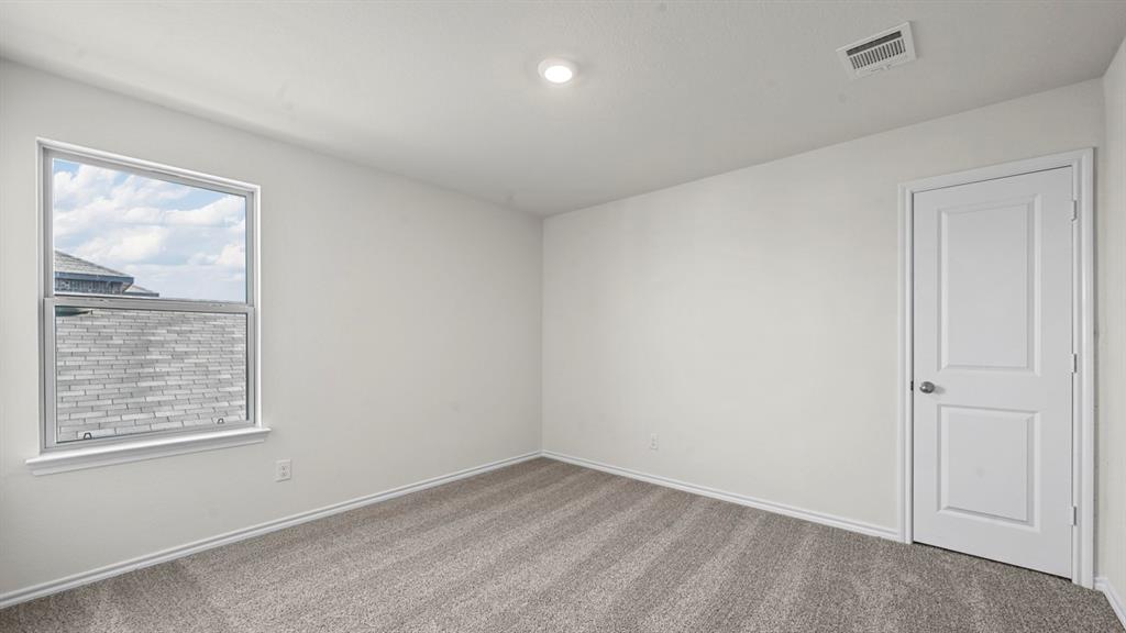 Recessed lighting, light gray carpeting, single window, white paneled door, and white painted walls