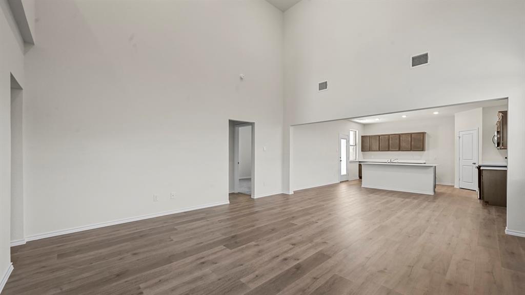 Soaring ceilings, wood-finish flooring, and an open-concept layout