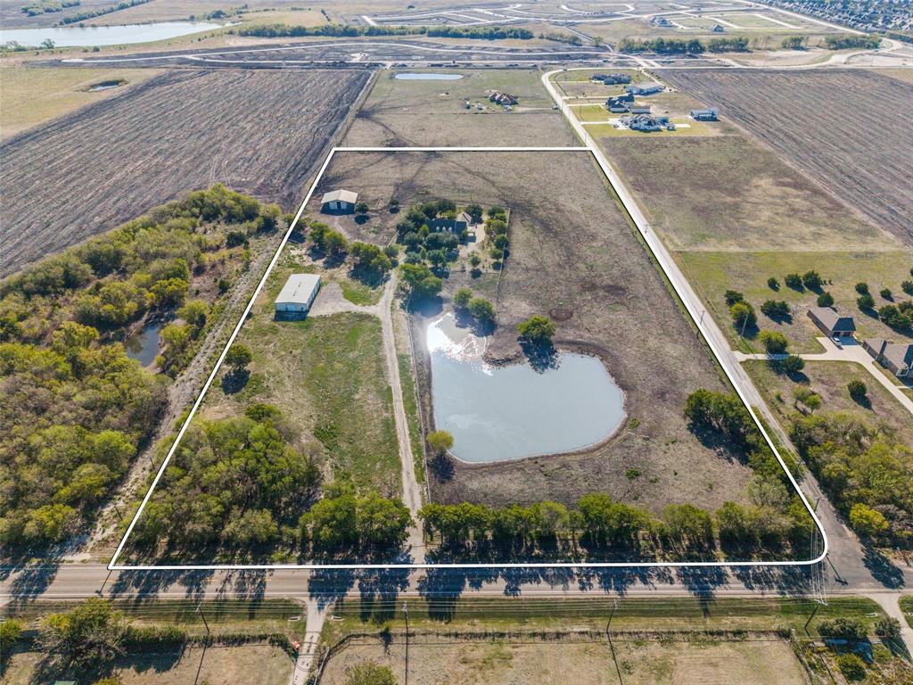 Expansive acreage featuring a private heart-shaped pond, barn, workshop and mature tree clusters