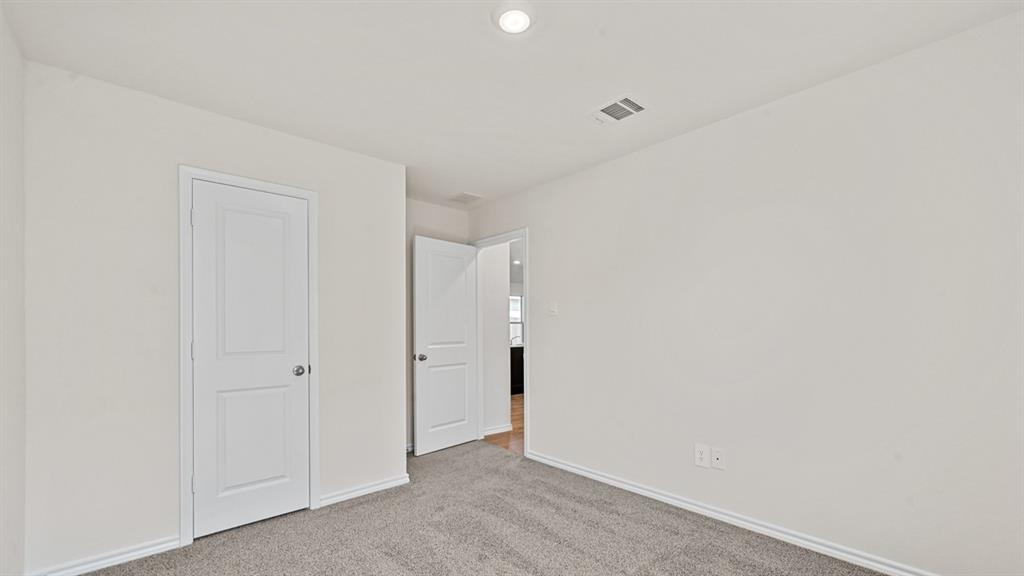 Neutral wall paint, gray carpet, and white trim