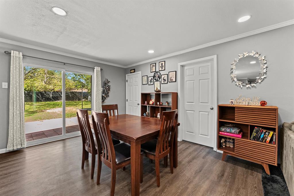 Neutral-toned room featuring wood-finish flooring, recessed lighting, and a sliding glass door providing external access