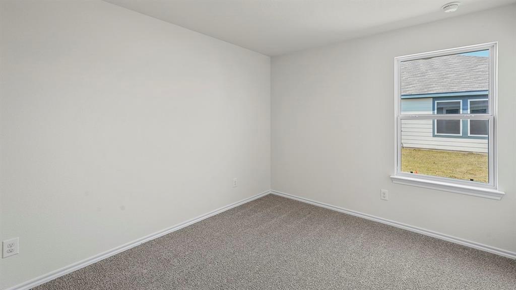 Interior space featuring neutral-toned carpeting and a single-hung window with white casing Interior space featuring neutral-toned carpeting and a single-hung window with white casing