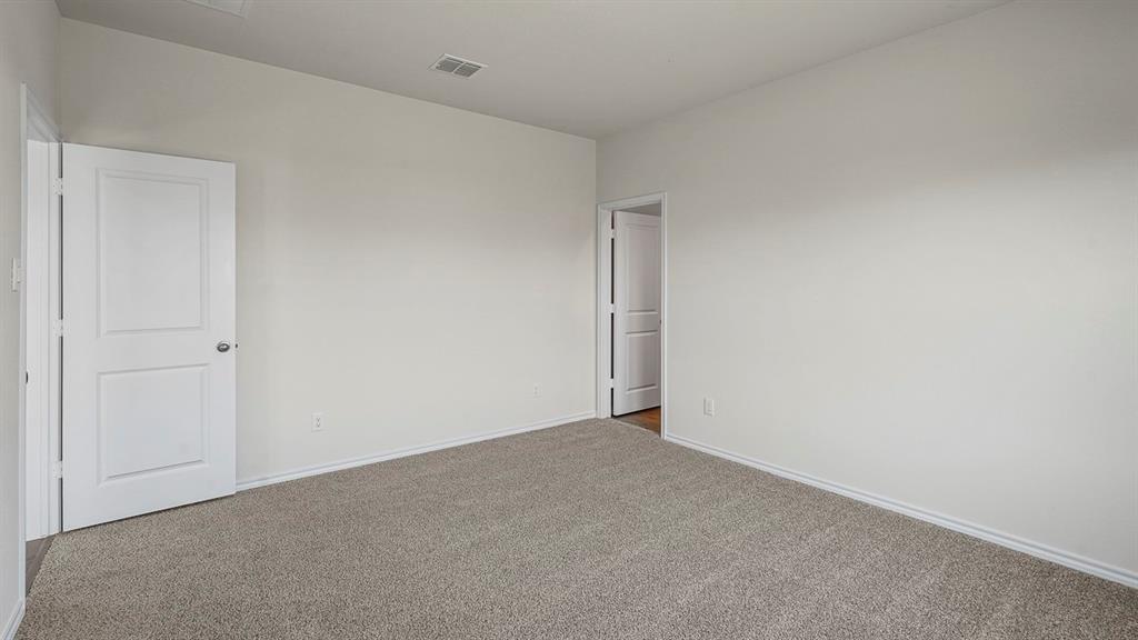 Neutral interior featuring neutral wall paint, wall-to-wall carpeting, and two-panel interior doors