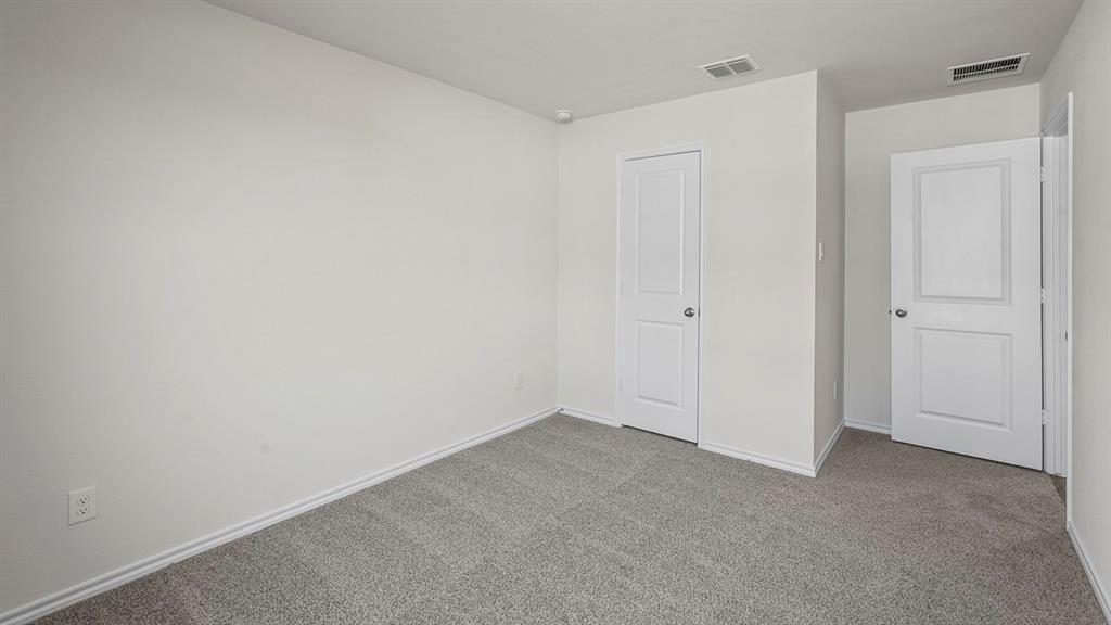 Neutral-toned carpeting, two-panel interior doors, and crisp white wall finish