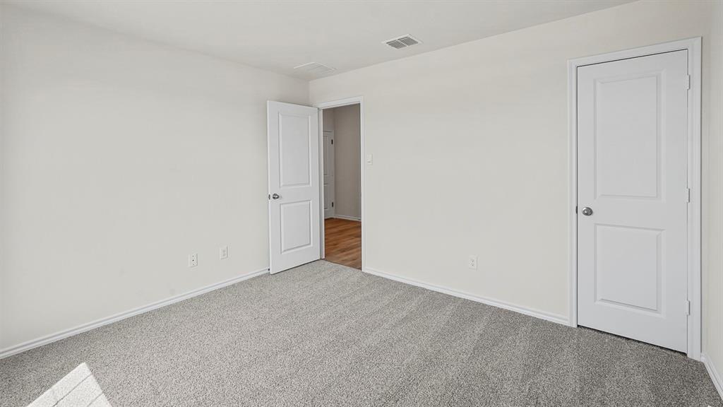 Neutral-toned carpeting, white two-panel doors, and crisp white wall finishes Neutral-toned carpeting, white two-panel doors, and crisp white wall finishes