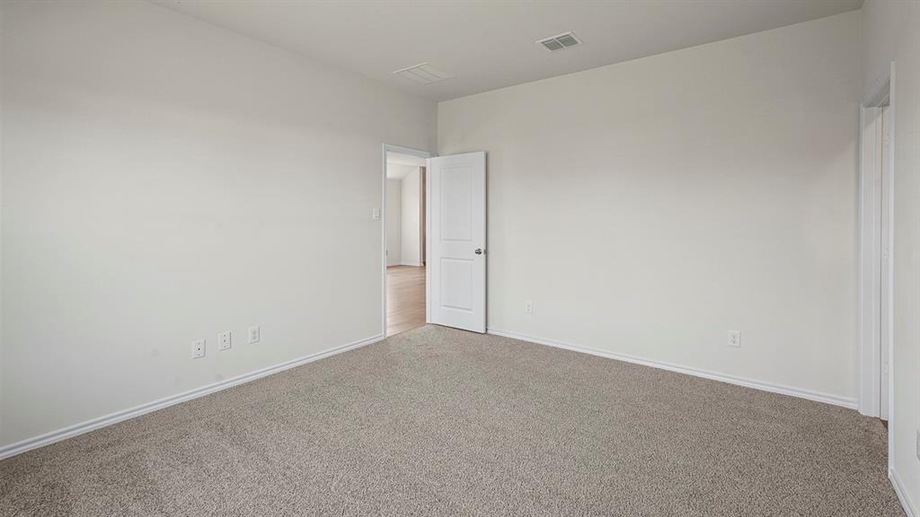 Neutral wall color, carpeted flooring, and white interior doors