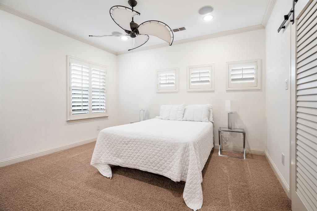 Room featuring crown molding, neutral carpeting, plantation shutters, recessed lighting, and a dual-blade ceiling fan