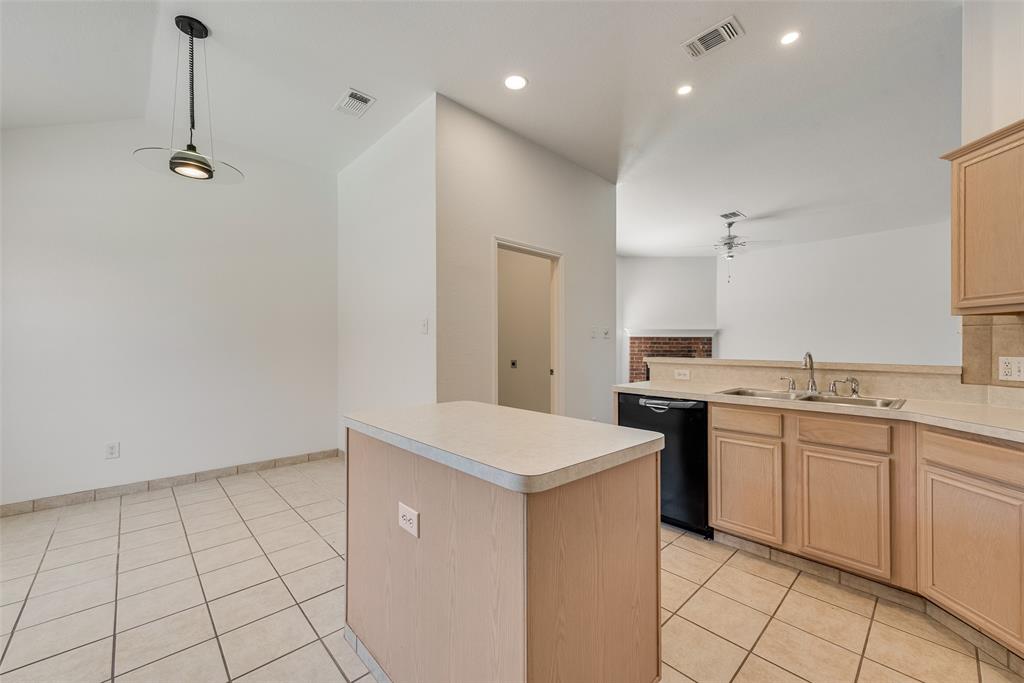 Kitchen featuring a central island, light-finish cabinetry, tile flooring, recessed lighting, and a pendant fixture