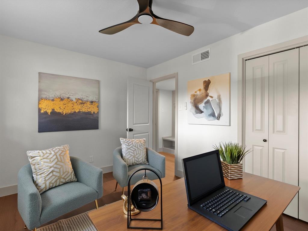 Room featuring wood-finish flooring, a three-blade ceiling fan, and double-panel closet doors