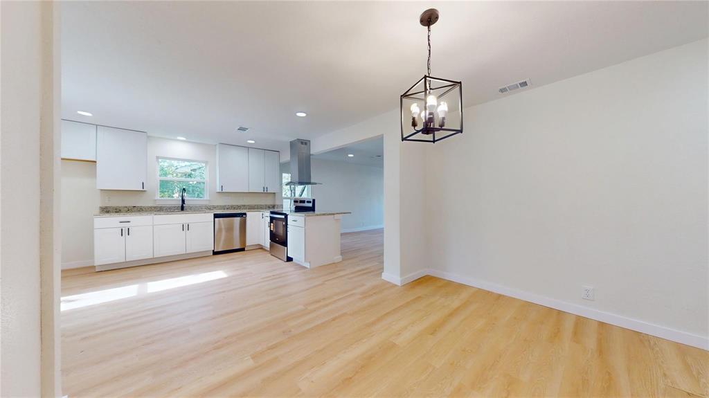 Kitchen featuring white cabinetry, stone-finish countertops, stainless steel appliances, recessed lighting, and wood-finish flooring with a hanging cage pendant light fixture