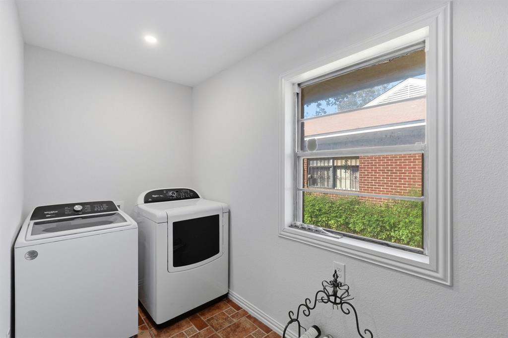 Utility room featuring recessed ceiling lighting, a dual-pane window with white trim, and ceramic tile flooring