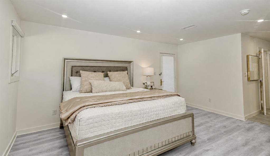 Primary Bedroom suite featuring wood-finish flooring, recessed lighting, and a neutral color palette Primary Bedroom suite featuring wood-finish flooring, recessed lighting, and a neutral color palette