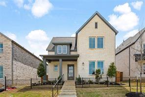 Two-story exterior featuring light-toned brick masonry, a covered front porch with dark structural columns, multi-pane windows, and a metal perimeter fence Two-story exterior featuring light-toned brick masonry, a covered front porch with dark structural columns, multi-pane windows, and a metal perimeter fence